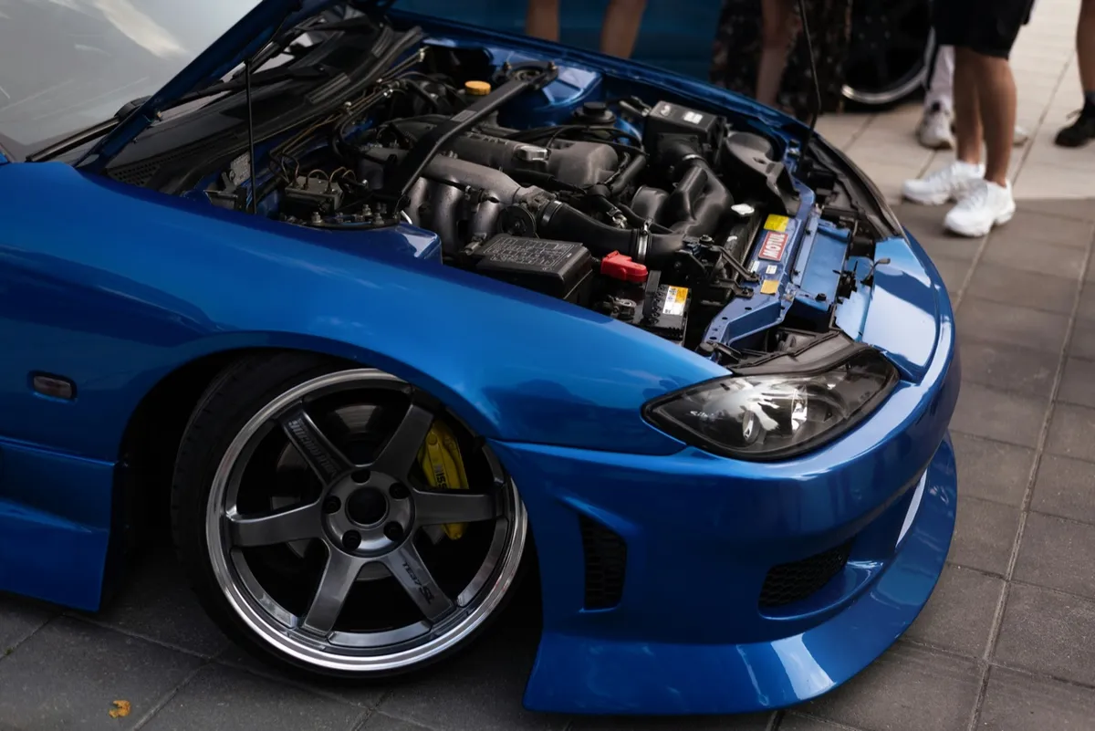 Blue Nissan Silvia S15 with the bonnet up at a car meet
